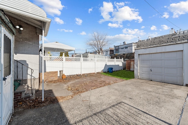 view of yard featuring a garage and an outbuilding