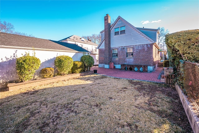 rear view of property featuring a patio area