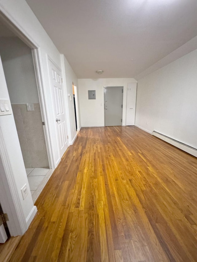 interior space featuring light hardwood / wood-style floors and a baseboard heating unit