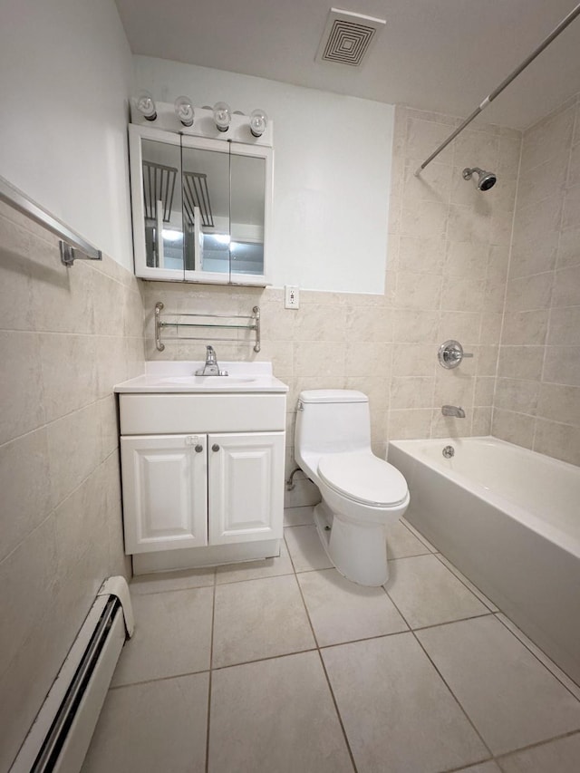 full bathroom with baseboard heating, tiled shower / bath, tile patterned floors, tile walls, and toilet