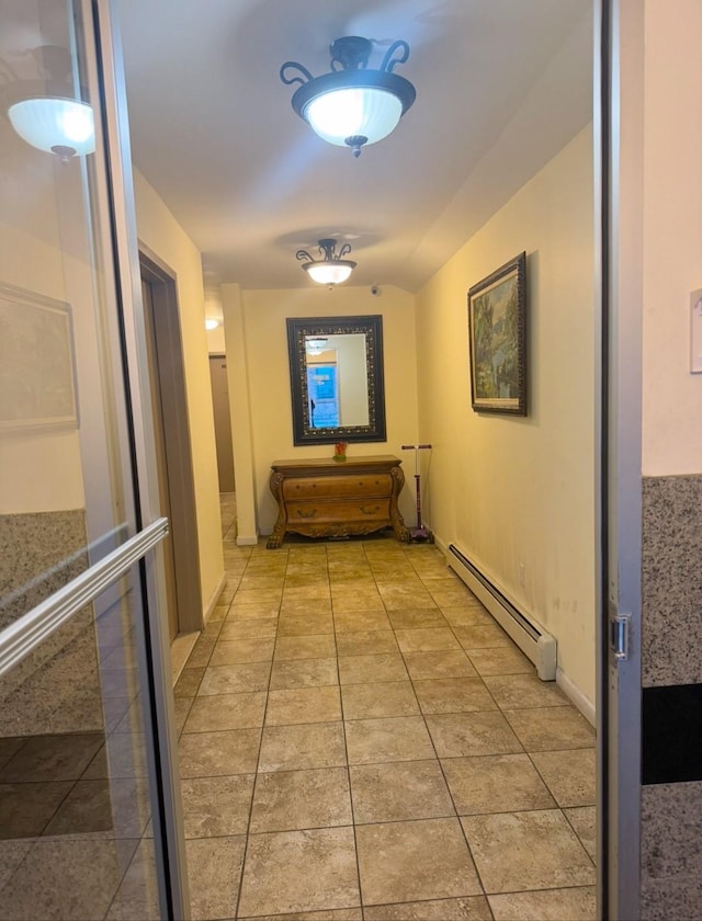 hall featuring light tile patterned flooring and a baseboard radiator