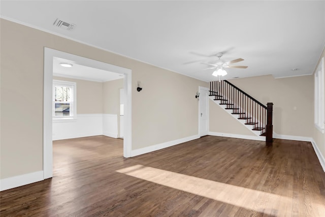 interior space with ceiling fan, crown molding, and dark wood-type flooring