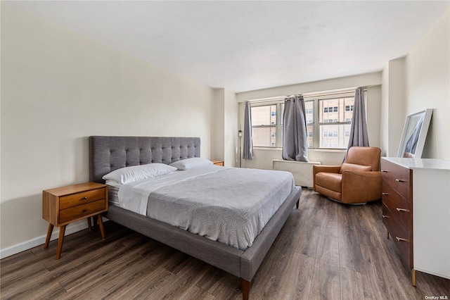 bedroom with dark hardwood / wood-style flooring