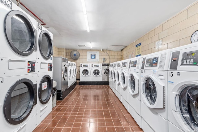 laundry area with stacked washer and clothes dryer and independent washer and dryer