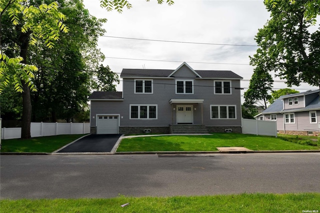 view of front of home featuring a front lawn and a garage