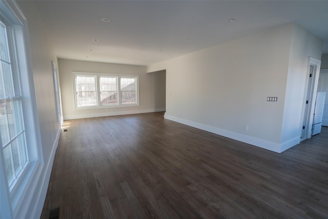 spare room with dark hardwood / wood-style floors