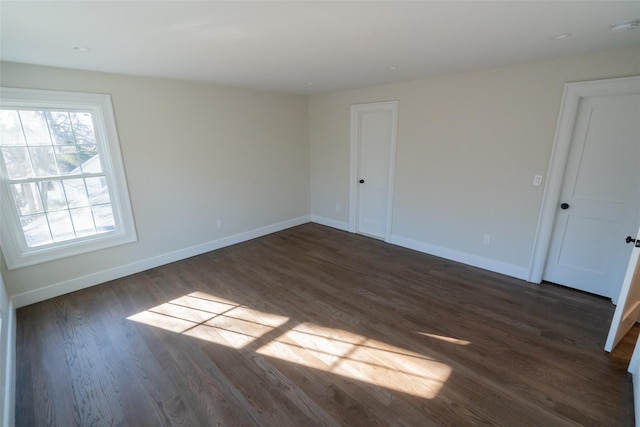 empty room featuring dark wood-type flooring