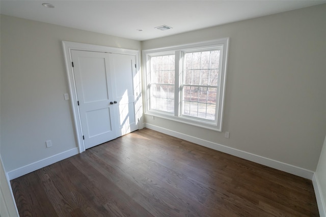 empty room featuring dark hardwood / wood-style flooring