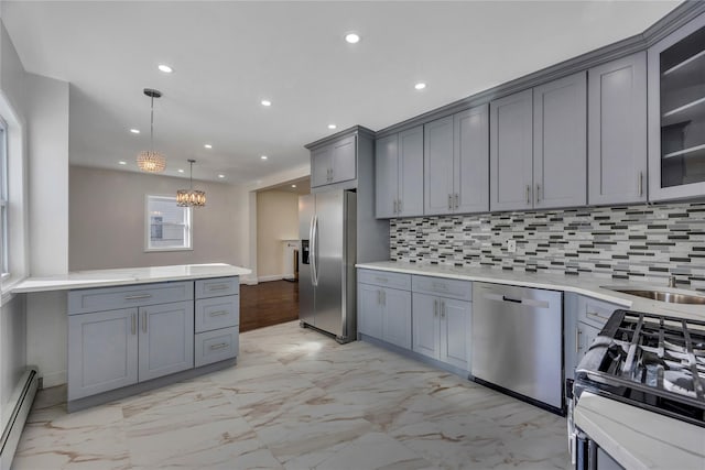 kitchen with baseboard heating, backsplash, decorative light fixtures, gray cabinets, and appliances with stainless steel finishes