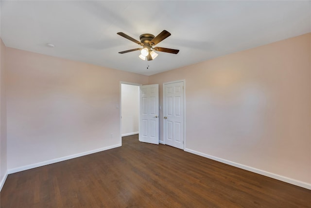 spare room featuring ceiling fan and dark wood-type flooring