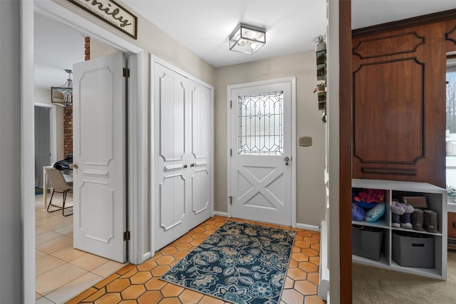 doorway with light tile patterned floors