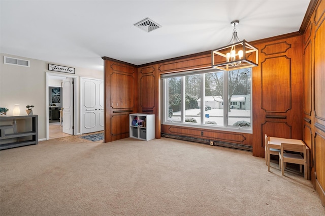 carpeted living room featuring a notable chandelier