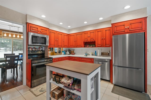 kitchen with light tile patterned floors, appliances with stainless steel finishes, and sink