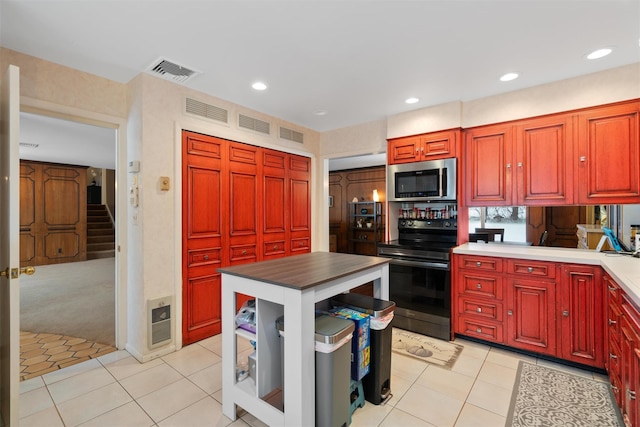 kitchen featuring electric range oven and light tile patterned floors