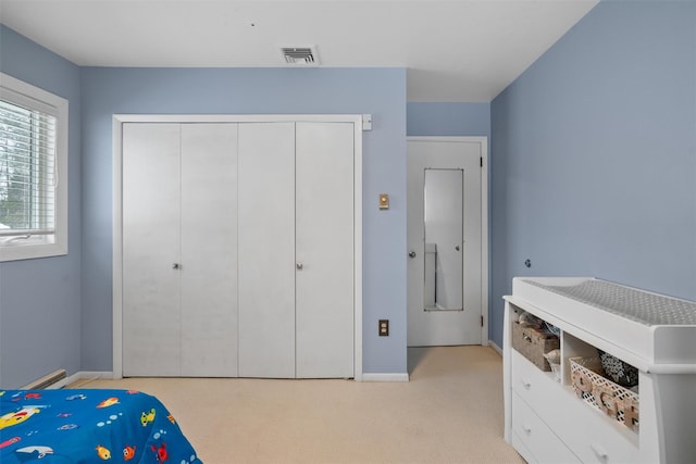 carpeted bedroom featuring a closet