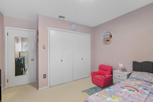 carpeted bedroom featuring a closet