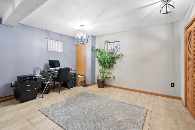 tiled home office with wood walls and a notable chandelier