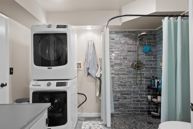 bathroom featuring toilet, tile patterned flooring, stacked washer / dryer, a shower with curtain, and vanity