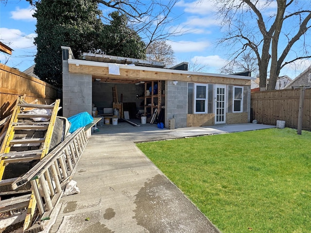 rear view of property with a patio area and a yard