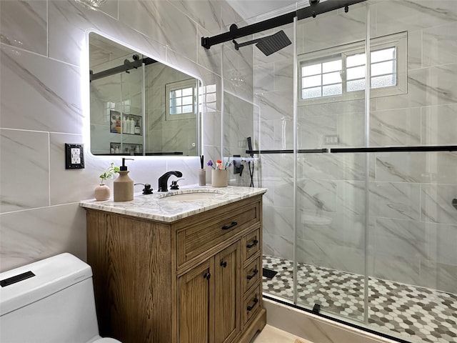 bathroom featuring a shower with door, vanity, and toilet