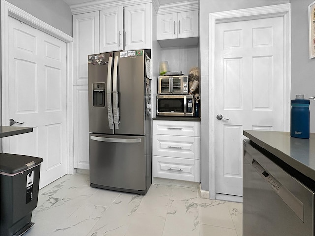 kitchen with appliances with stainless steel finishes and white cabinetry