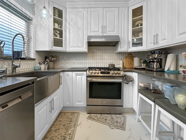 kitchen featuring white cabinets, appliances with stainless steel finishes, and decorative light fixtures