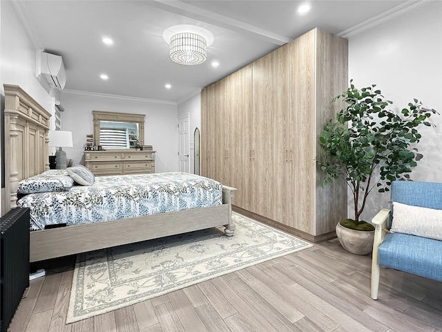 bedroom with light hardwood / wood-style floors, an inviting chandelier, a wall mounted AC, and ornamental molding