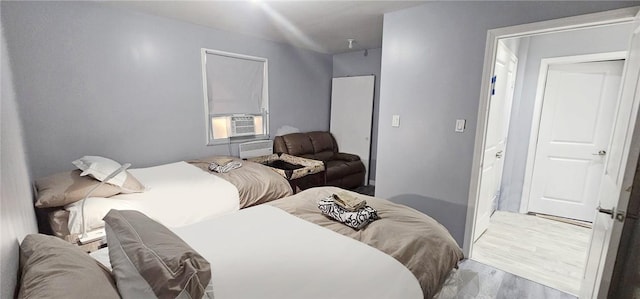 bedroom featuring light wood-type flooring and cooling unit