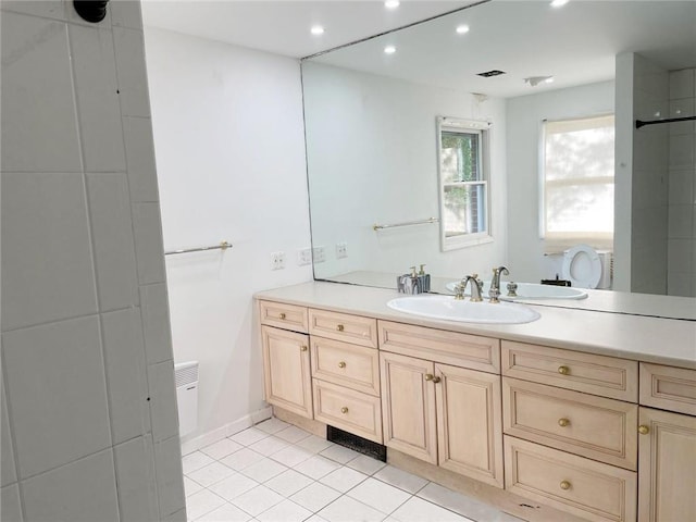 bathroom with tile patterned flooring and vanity