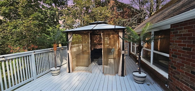 wooden terrace featuring a gazebo