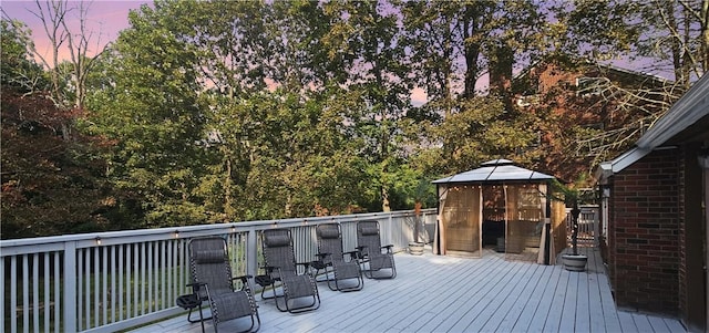 deck at dusk with a gazebo