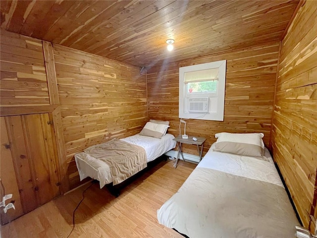 bedroom with light hardwood / wood-style floors, wood ceiling, and wood walls