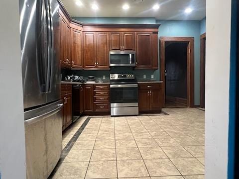 kitchen featuring light tile patterned floors and stainless steel appliances