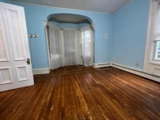 unfurnished bedroom with dark hardwood / wood-style flooring and multiple windows