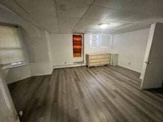 basement with baseboard heating and hardwood / wood-style floors