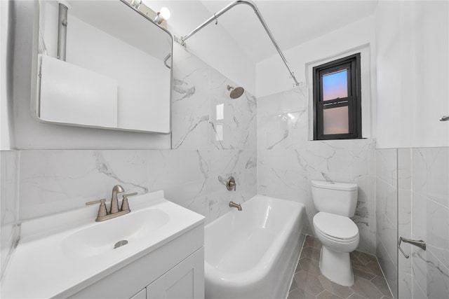 full bathroom featuring vanity, bathing tub / shower combination, tile patterned flooring, toilet, and tile walls