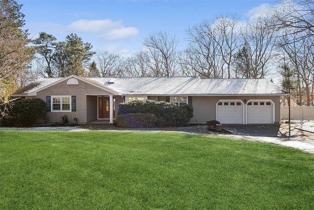 ranch-style home with a garage and a front yard