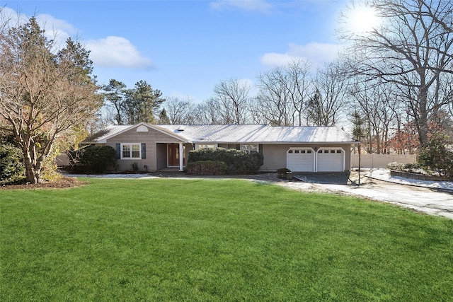 ranch-style home with a garage and a front yard