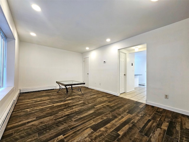 spare room with light wood-type flooring and a baseboard heating unit