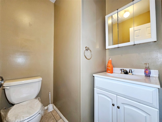 bathroom with tile patterned flooring, vanity, and toilet