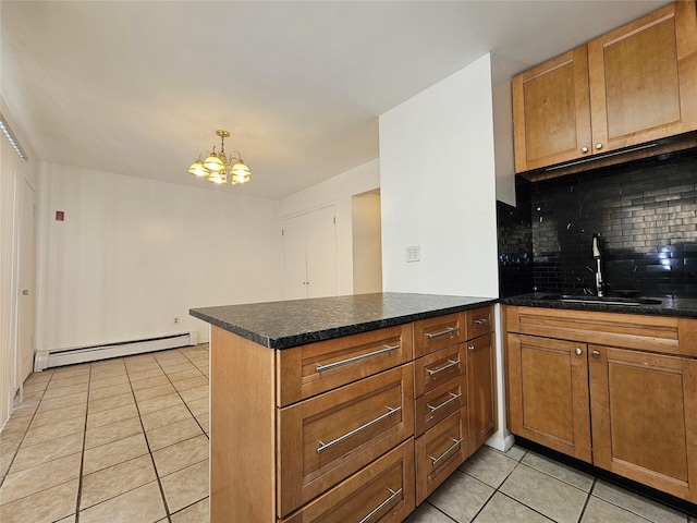 kitchen featuring kitchen peninsula, a baseboard heating unit, sink, light tile patterned floors, and a notable chandelier