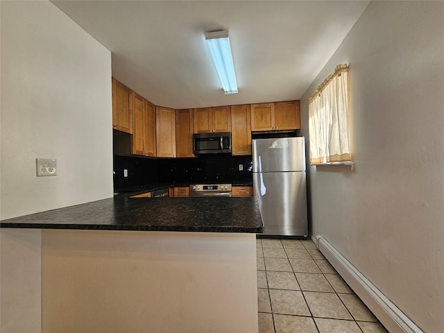 kitchen featuring a baseboard radiator, kitchen peninsula, decorative backsplash, light tile patterned floors, and appliances with stainless steel finishes