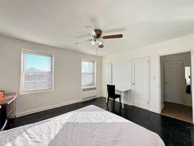 bedroom with ceiling fan and radiator heating unit