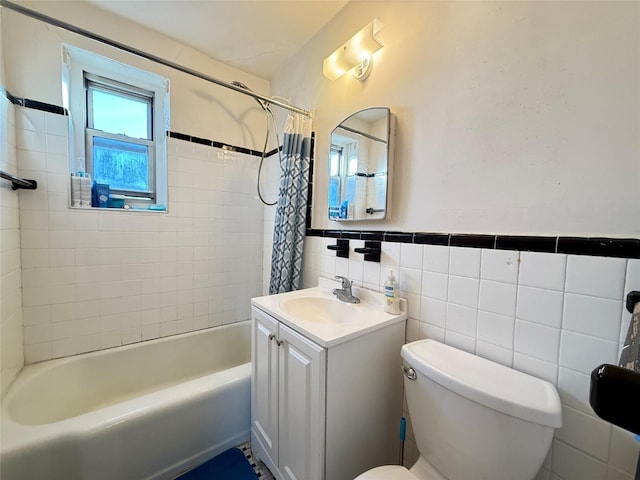 full bathroom with shower / tub combo, vanity, tile walls, and toilet