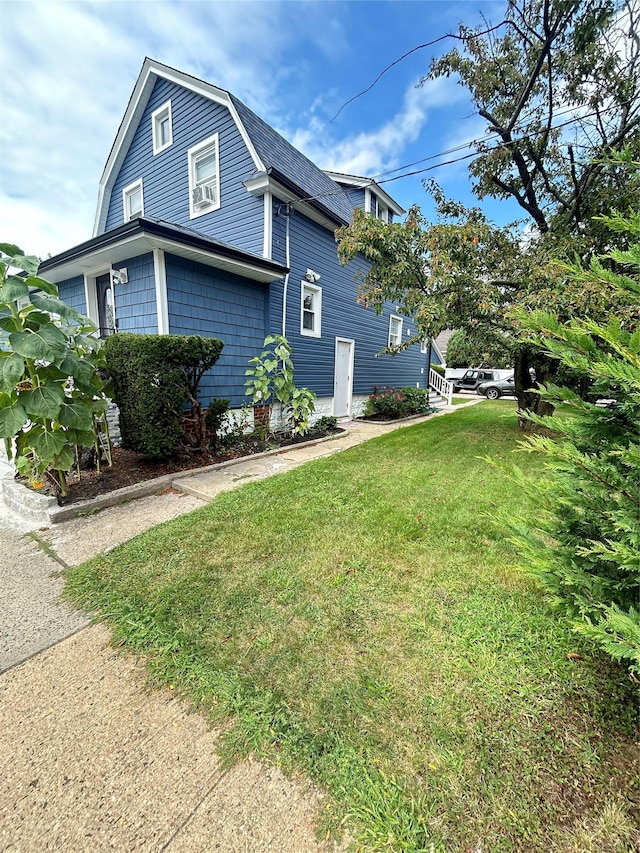 view of home's exterior with a lawn