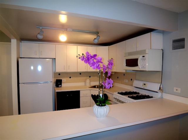 kitchen with white cabinetry, tasteful backsplash, white appliances, and track lighting