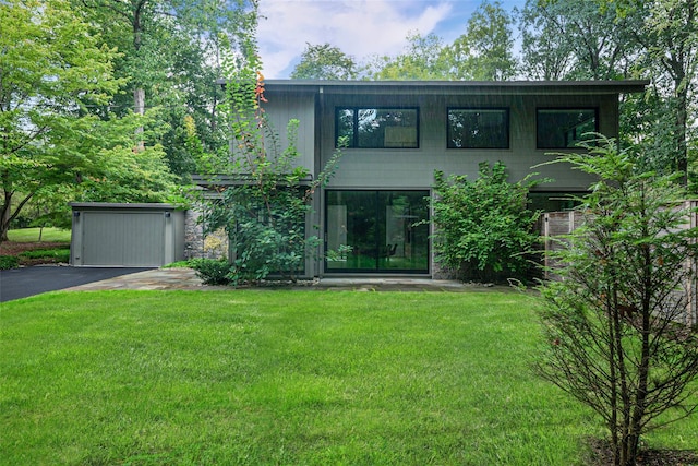 exterior space with a yard and aphalt driveway