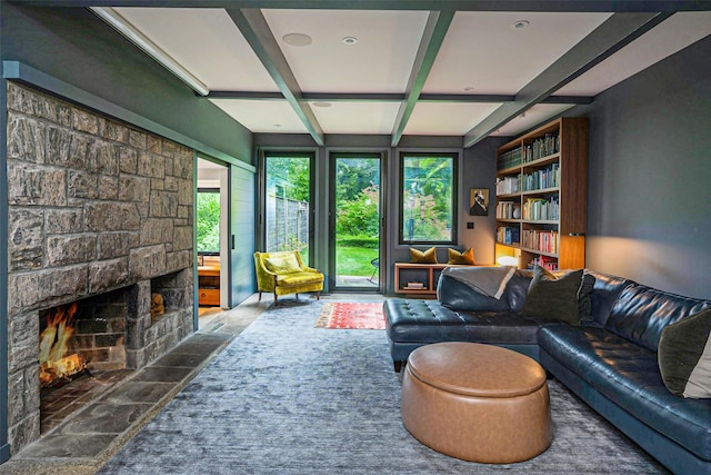 living area with a fireplace, coffered ceiling, and beam ceiling