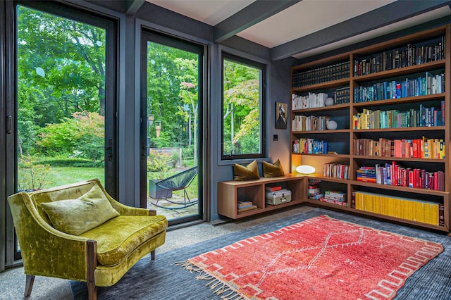 sitting room with a wealth of natural light and beam ceiling