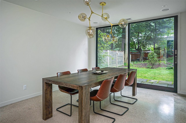 dining room with baseboards, a chandelier, and speckled floor